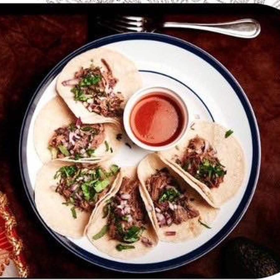 A plate of Aztecas tacos with salsa